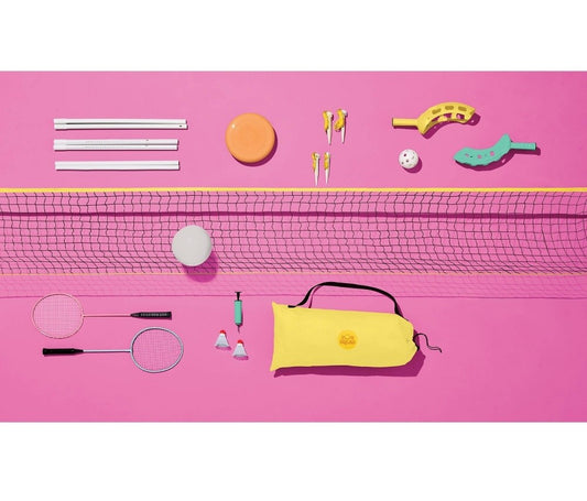 Badminton and volleyball equipment on a pink background